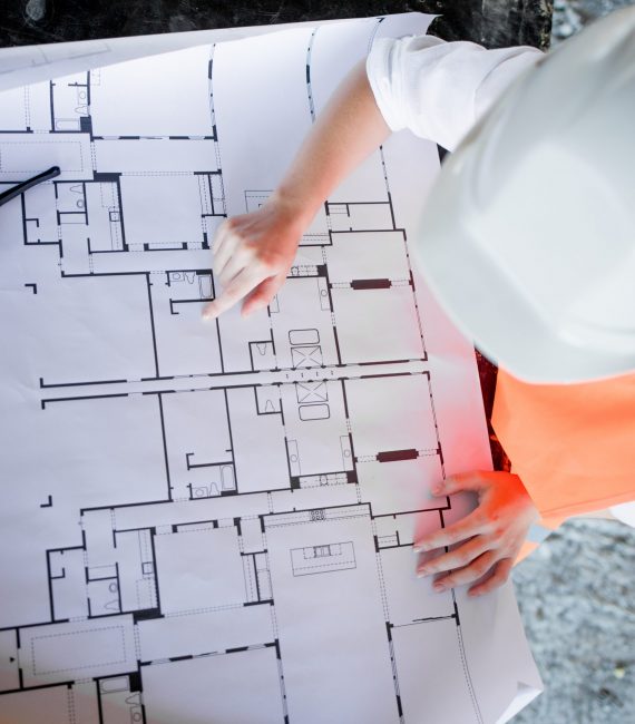 Architect working over plan. Closeup Desk With blueprints drawing